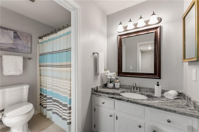 bathroom featuring vanity, toilet, and a shower with shower curtain