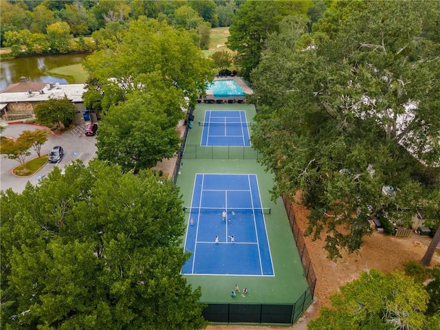 view of sport court with a water view