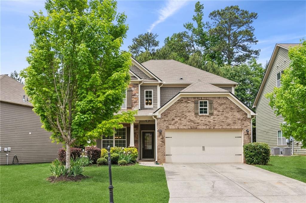 craftsman-style home with a garage and a front yard