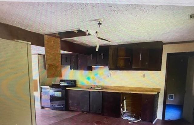 kitchen with electric range, visible vents, light countertops, dark brown cabinets, and a sink