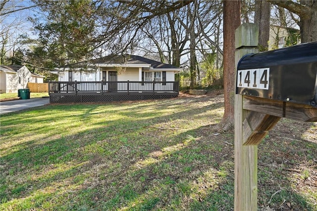 view of front facade with a front yard and a deck