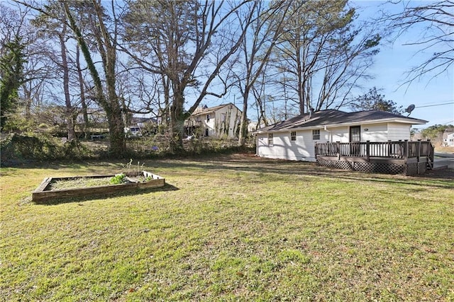 view of yard with a deck and a garden