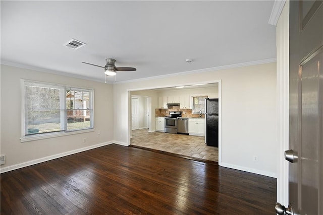 unfurnished living room featuring ornamental molding, hardwood / wood-style flooring, visible vents, and baseboards