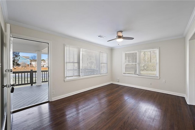 spare room featuring dark wood-style floors, baseboards, visible vents, and ornamental molding