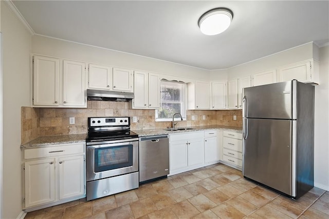 kitchen with light stone counters, a sink, stainless steel appliances, under cabinet range hood, and backsplash