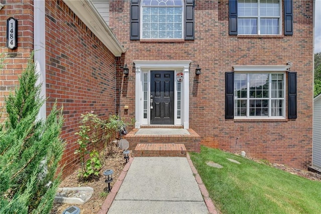 doorway to property featuring a yard