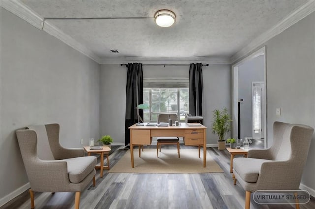 living area with hardwood / wood-style floors and crown molding