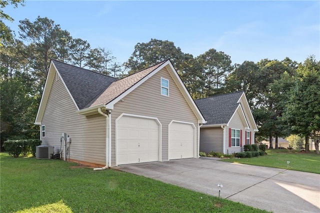 view of front facade with a garage, central AC, and a front yard