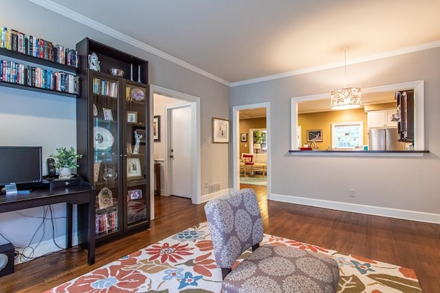 sitting room with dark hardwood / wood-style flooring and ornamental molding