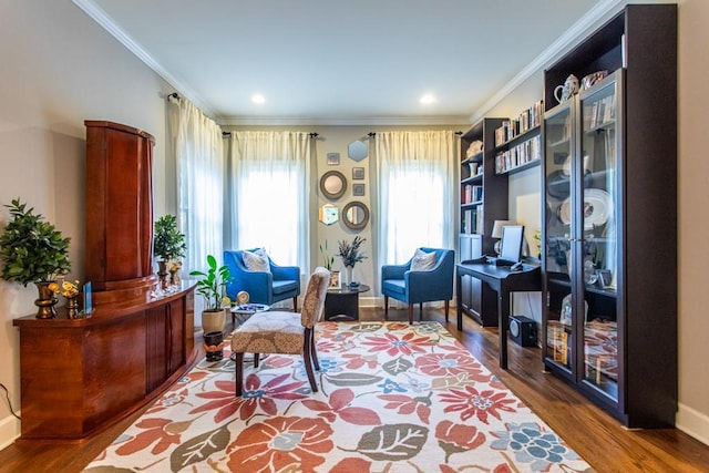 sitting room with crown molding and dark hardwood / wood-style flooring