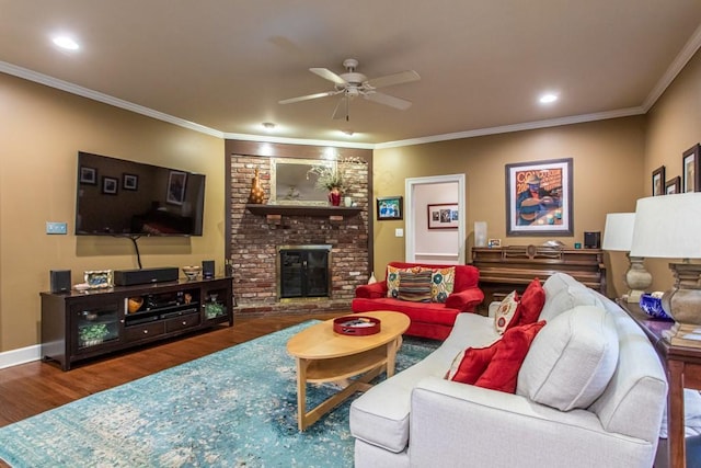 living room featuring brick wall, a brick fireplace, ceiling fan, ornamental molding, and dark wood-type flooring