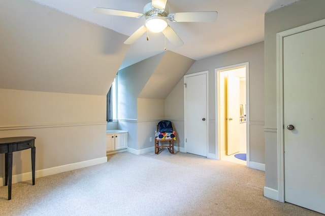 additional living space with light carpet, lofted ceiling, and ceiling fan