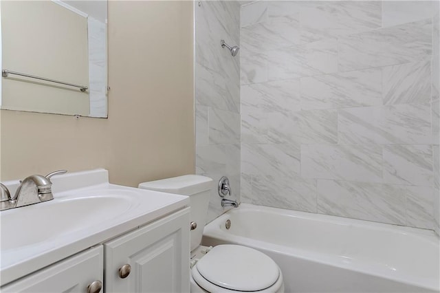 full bathroom with vanity, tiled shower / bath combo, and toilet