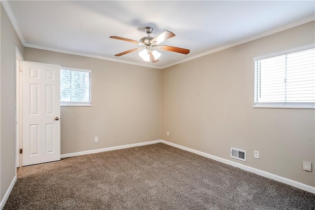 empty room with ceiling fan, ornamental molding, and carpet floors