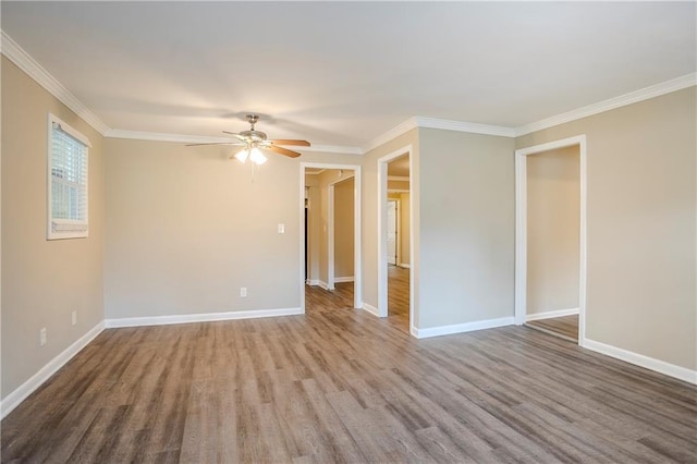 empty room with crown molding, wood-type flooring, and ceiling fan