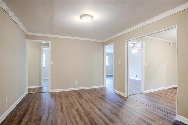 spare room with crown molding and wood-type flooring