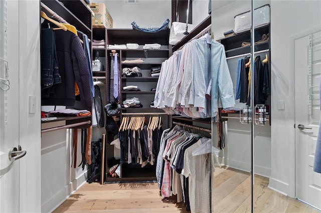 walk in closet featuring hardwood / wood-style floors