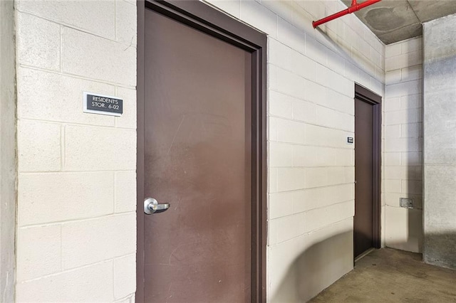 view of exterior entry with concrete block siding