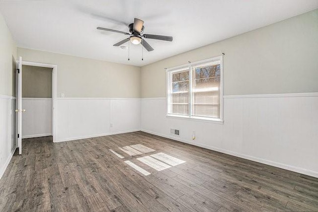 spare room featuring dark hardwood / wood-style floors and ceiling fan