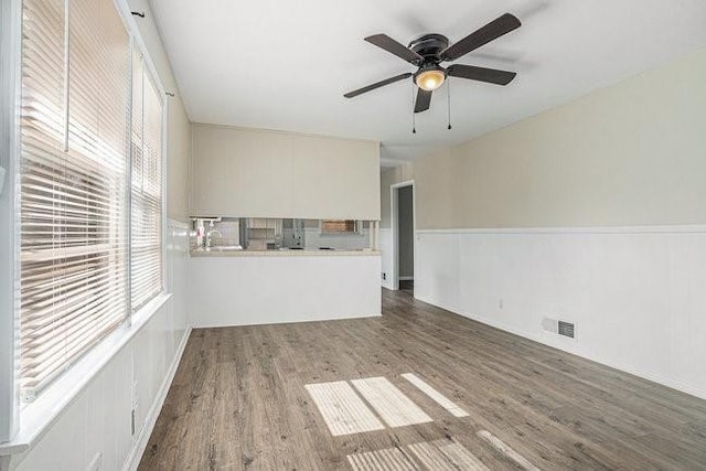 unfurnished living room featuring hardwood / wood-style floors and ceiling fan