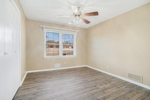 empty room featuring ceiling fan and wood-type flooring