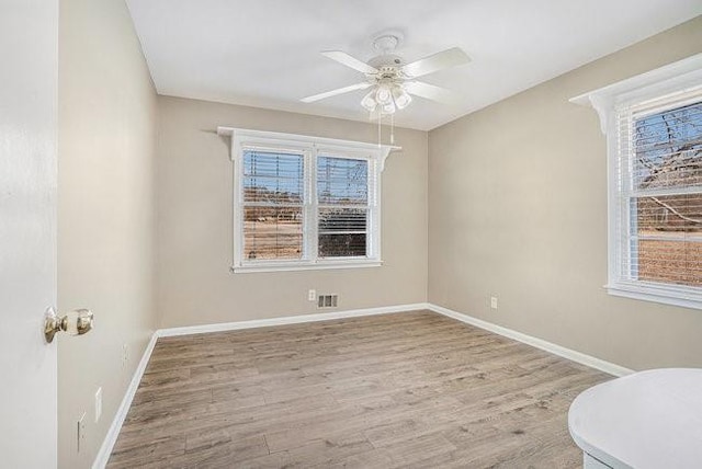 spare room featuring ceiling fan and light hardwood / wood-style floors