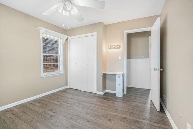 unfurnished bedroom with wood-type flooring, a closet, and ceiling fan