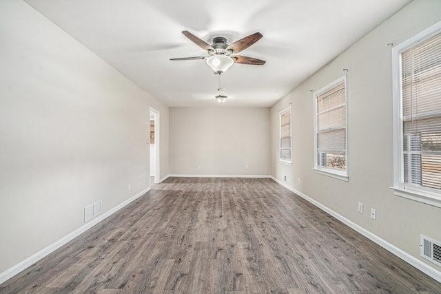 spare room with dark hardwood / wood-style floors and ceiling fan