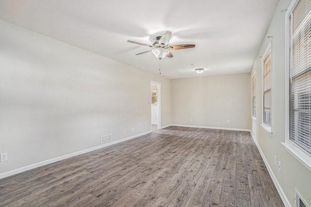 unfurnished room with hardwood / wood-style floors and ceiling fan