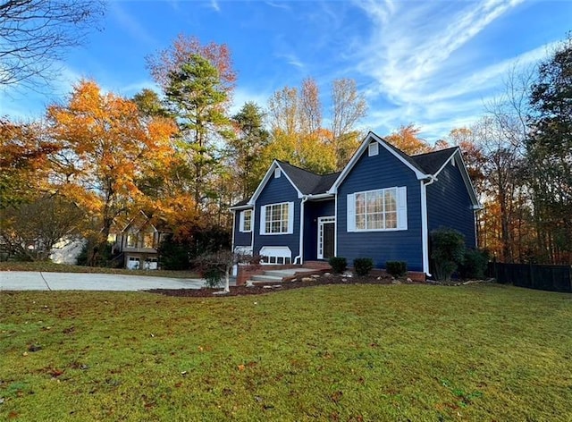 view of front of property featuring a front lawn and concrete driveway