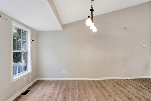 unfurnished dining area featuring baseboards, visible vents, and light wood-style flooring
