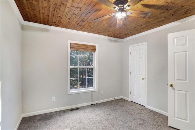 unfurnished bedroom with carpet flooring, visible vents, crown molding, baseboards, and wood ceiling