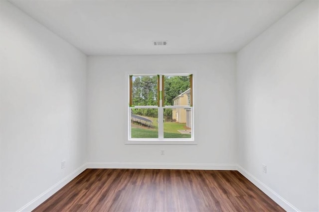 empty room featuring dark hardwood / wood-style flooring