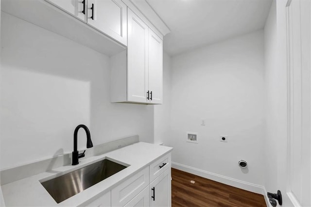 clothes washing area with cabinets, dark wood-type flooring, sink, hookup for a washing machine, and hookup for an electric dryer