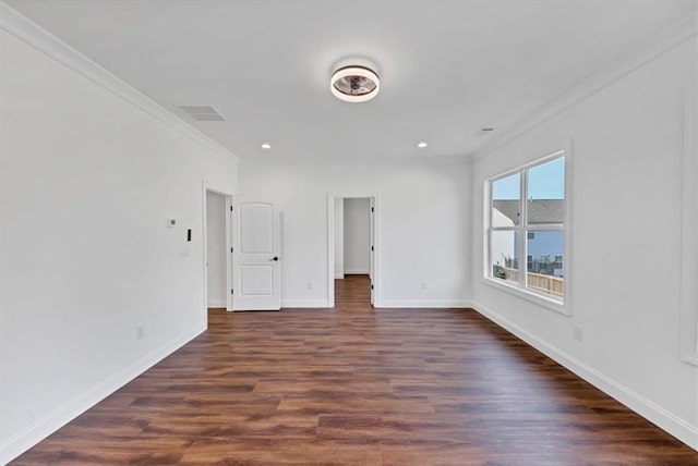 spare room with crown molding and dark hardwood / wood-style floors