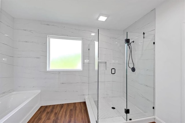 bathroom featuring hardwood / wood-style floors and separate shower and tub