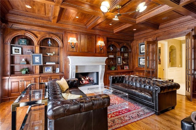 living room featuring built in features, wooden ceiling, crown molding, and wood walls