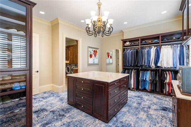 spacious closet featuring a chandelier, washer and clothes dryer, and carpet