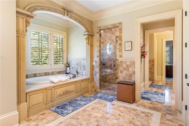 bathroom featuring ornamental molding, a healthy amount of sunlight, separate shower and tub, and tile walls