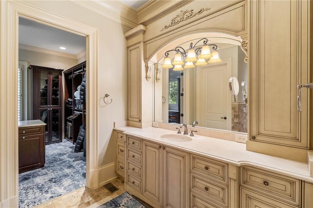 bathroom with ornamental molding and vanity