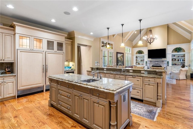 kitchen with pendant lighting, sink, and a center island with sink