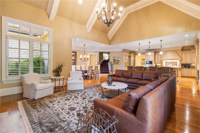 living room featuring an inviting chandelier, hardwood / wood-style flooring, high vaulted ceiling, and beamed ceiling