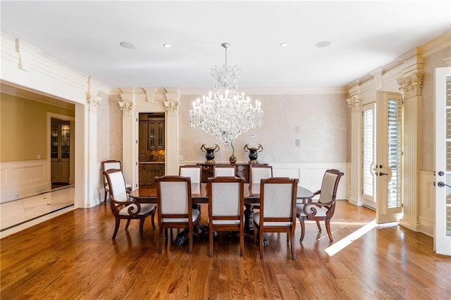 dining room featuring hardwood / wood-style flooring, ornamental molding, and a chandelier