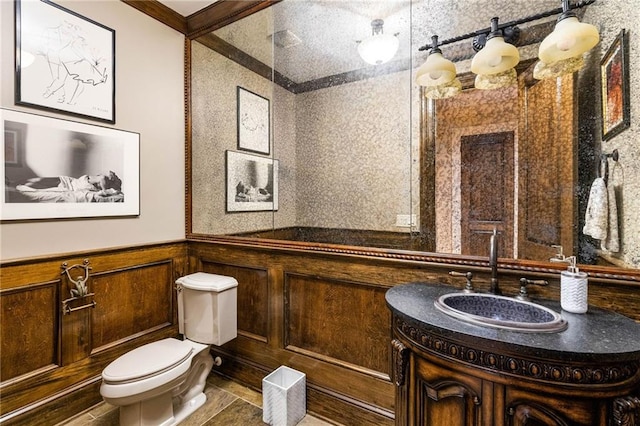 bathroom featuring vanity, ornamental molding, and toilet