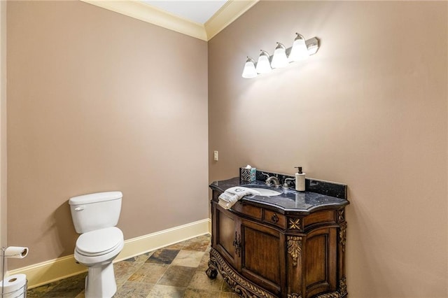 bathroom featuring vanity, ornamental molding, and toilet