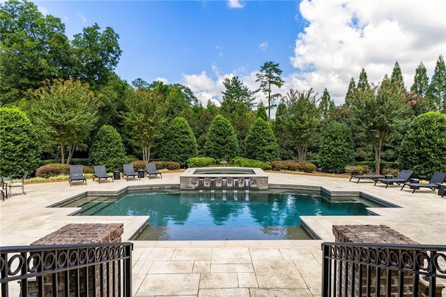 view of swimming pool with a patio area and an in ground hot tub