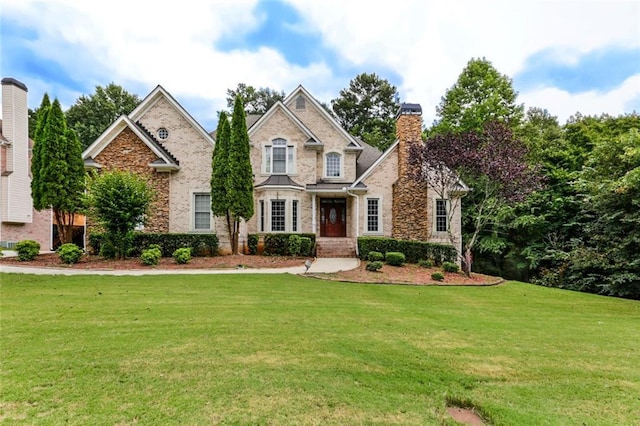 1360 Mount Mickinley Dr, Grayson, GA 30017 - view of front of house featuring a front yard, a chimney, stone siding, and brick siding