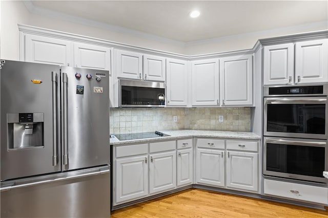 1360 Mount Mickinley Dr, Grayson, GA 30017 - kitchen featuring appliances with stainless steel finishes, light wood-style floors, ornamental molding, backsplash, and light stone countertops