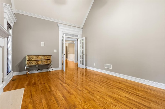 1360 Mount Mickinley Dr, Grayson, GA 30017 - spare room featuring crown molding, french doors, lofted ceiling, and light wood finished floors