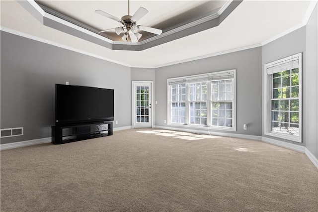 1360 Mount Mickinley Dr, Grayson, GA 30017 - unfurnished living room featuring a raised ceiling, crown molding, carpet flooring, and a ceiling fan